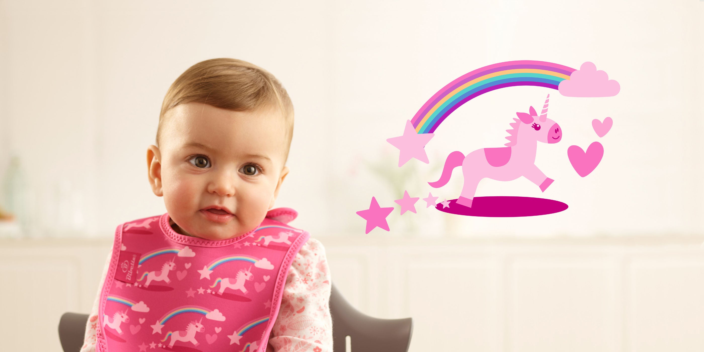 Toddler wearing a Bibetta Ultrabib neoprene weaning baby bib in pink Unicorns print
