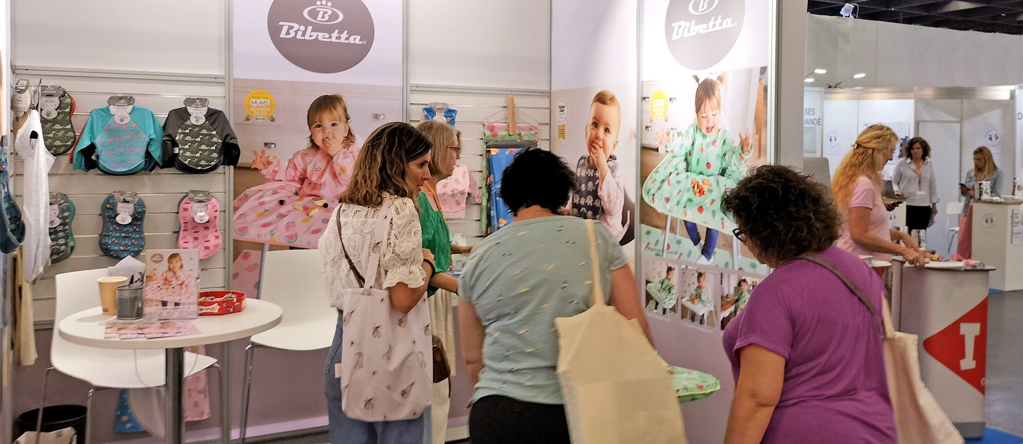 Bibetta exhibiting their baby products at Kind und Jugend baby show with visitors in the foreground