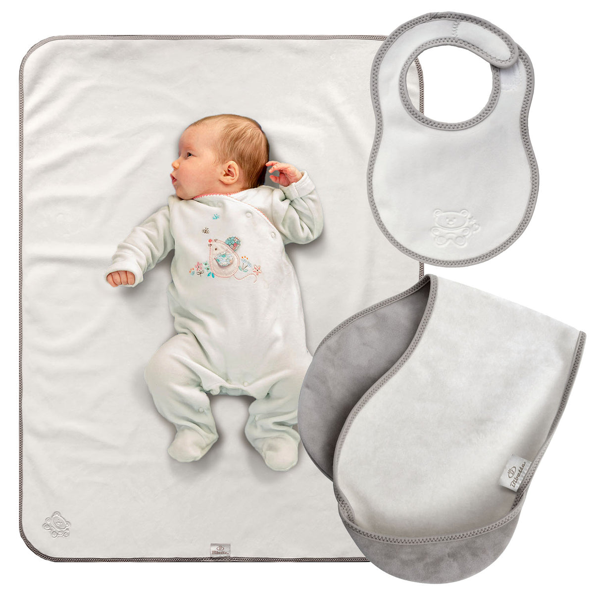 bibetta newborn plush white and grey baby bib, burp cloth and tummy time mat with a grey bias binding with a zig-zag stitch and a teddy embossed in the front on a white background. The burp loth in folded in half and has the pockets folded to the the front.