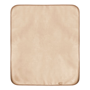 a photo of the front of Bibetta plush tummy time mat in cream with a Bibetta brand label and embossed teddy motif in the bottom right hand corner of the mat. 