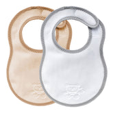Two bibetta newborn plush bibs, one cream and beige with beige  bias binding and one white and grey baby bib with a grey bias binding with a zig-zag stitch and a teddy embossed in the front on a white background