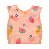 Bibetta wipeezee weaning bib in pink yummy treats pattern with the pocket folded to the back.