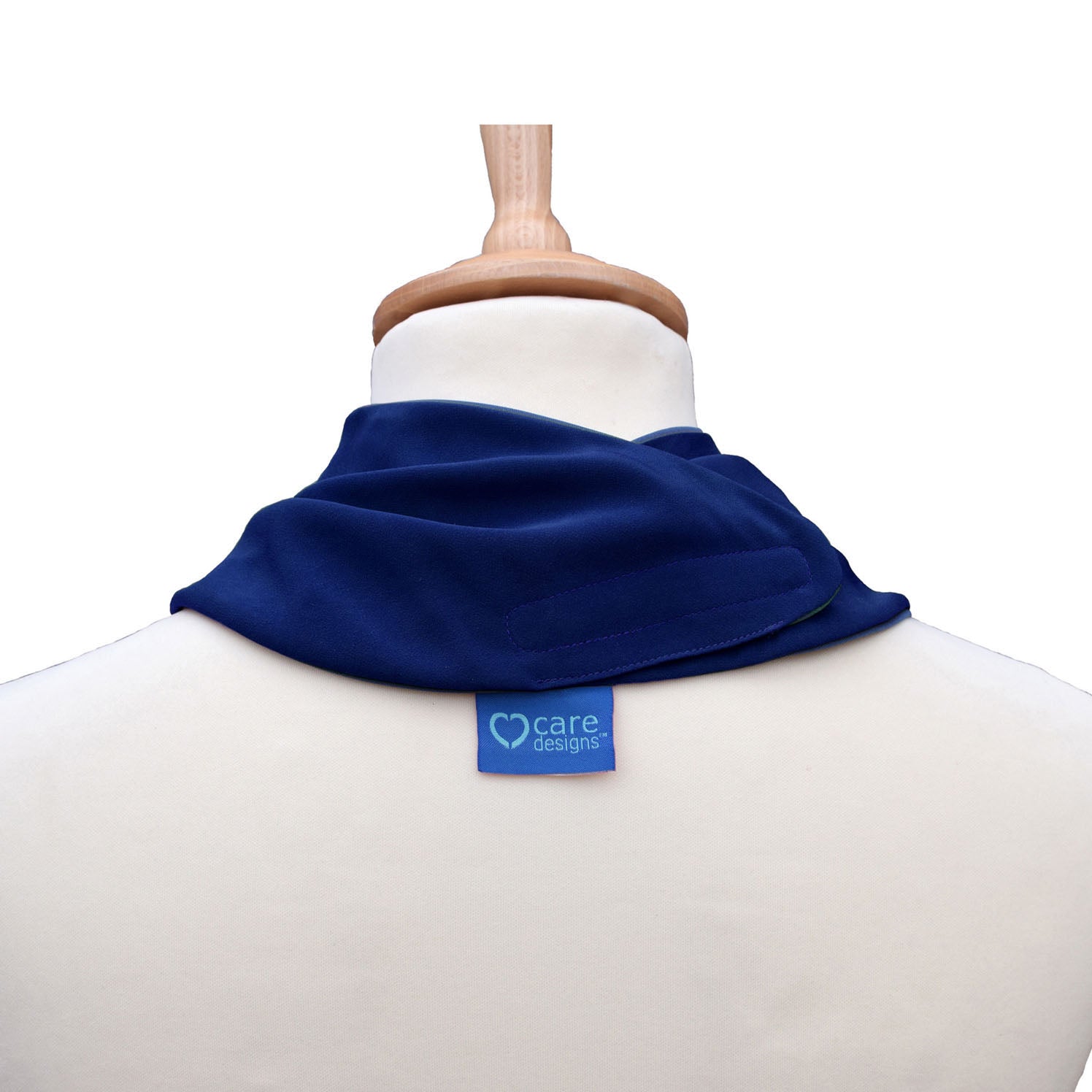 Back view of a navy neckerchief bib on a mannequin with 'care designs' label