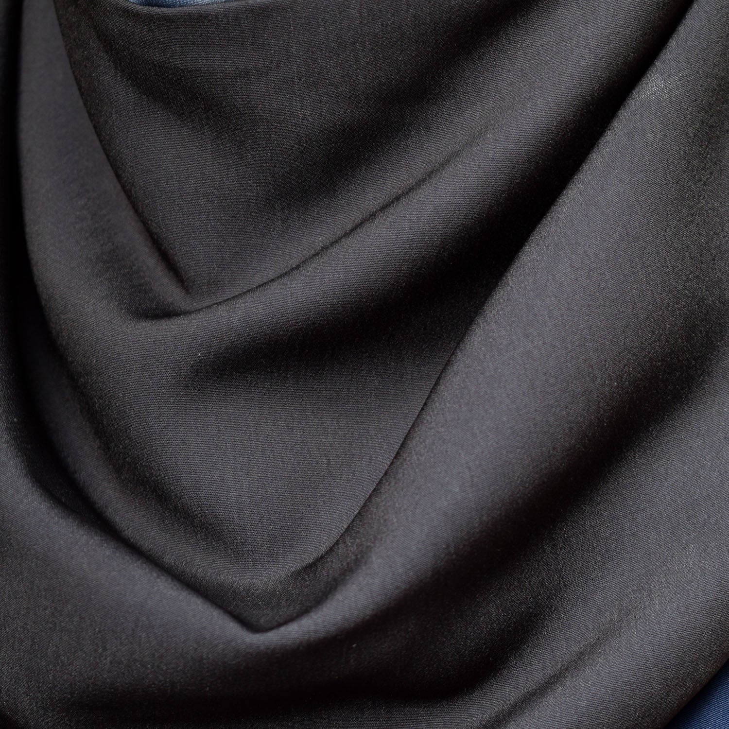 Close-up of charcoal black fabric with folds