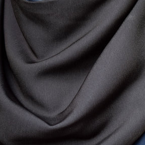 Close-up of charcoal black fabric with folds