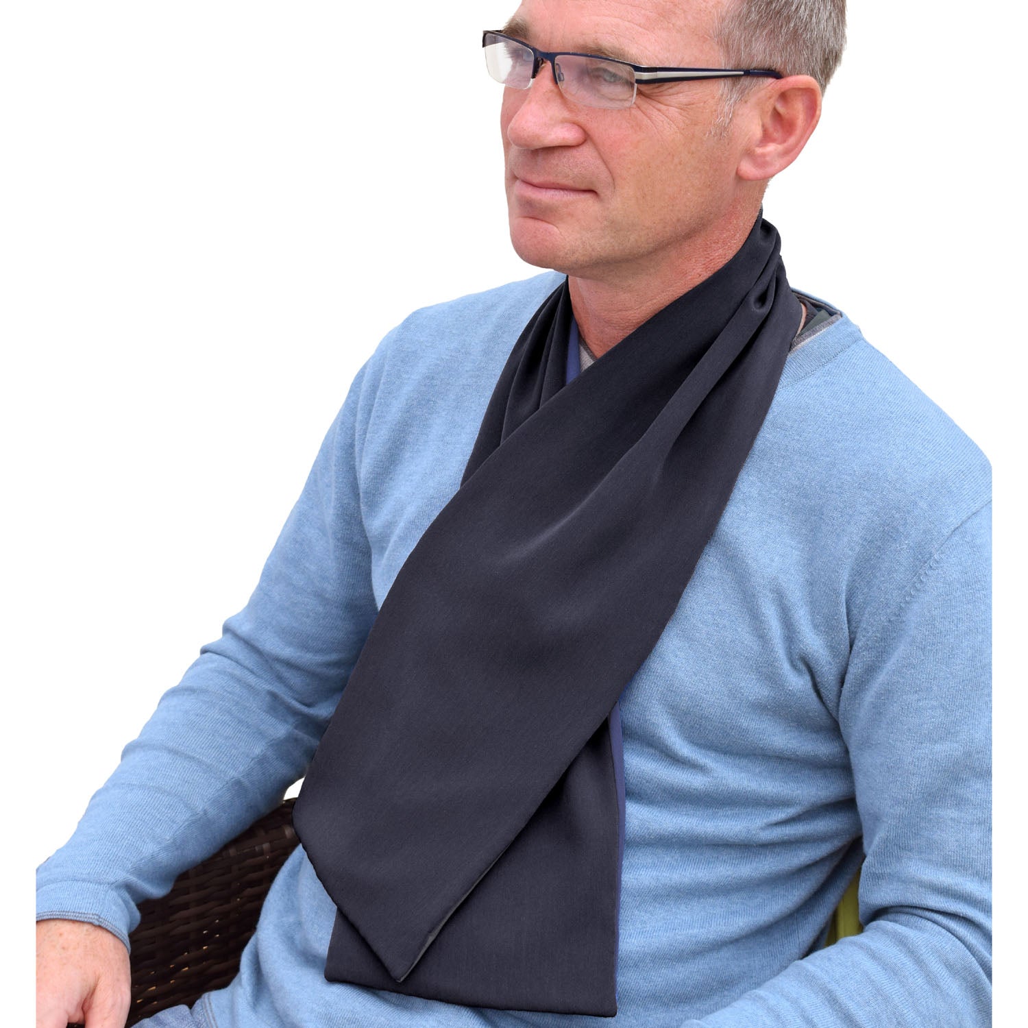 Man wearing a blue sweater and black cross scarf clothing protector on a white background