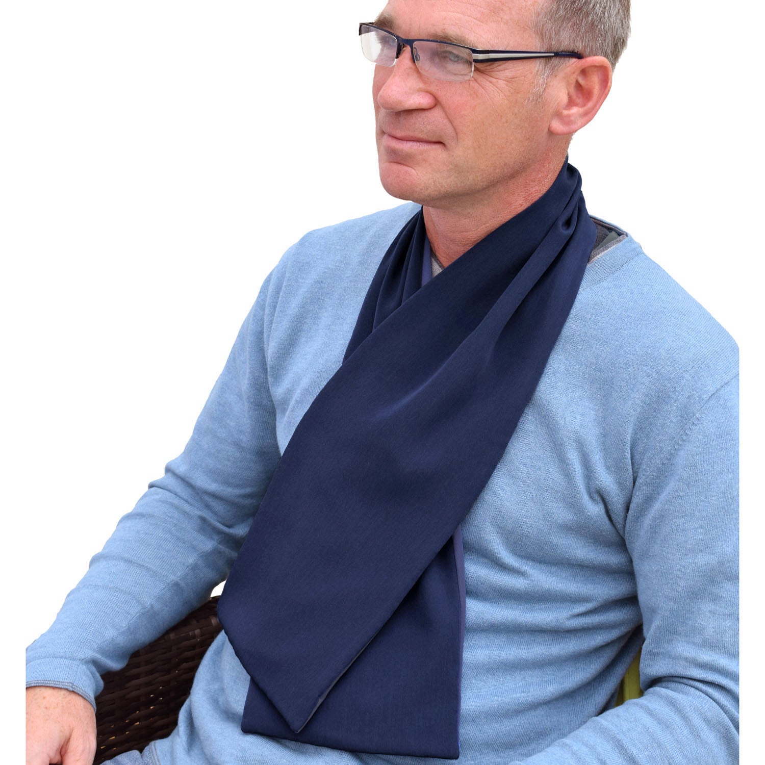 Man wearing a blue sweater and navy cross scarf clothing protector against a white background