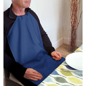 Person wearing a Care Designs long navy napkin sitting at a table with a colorful tablecloth