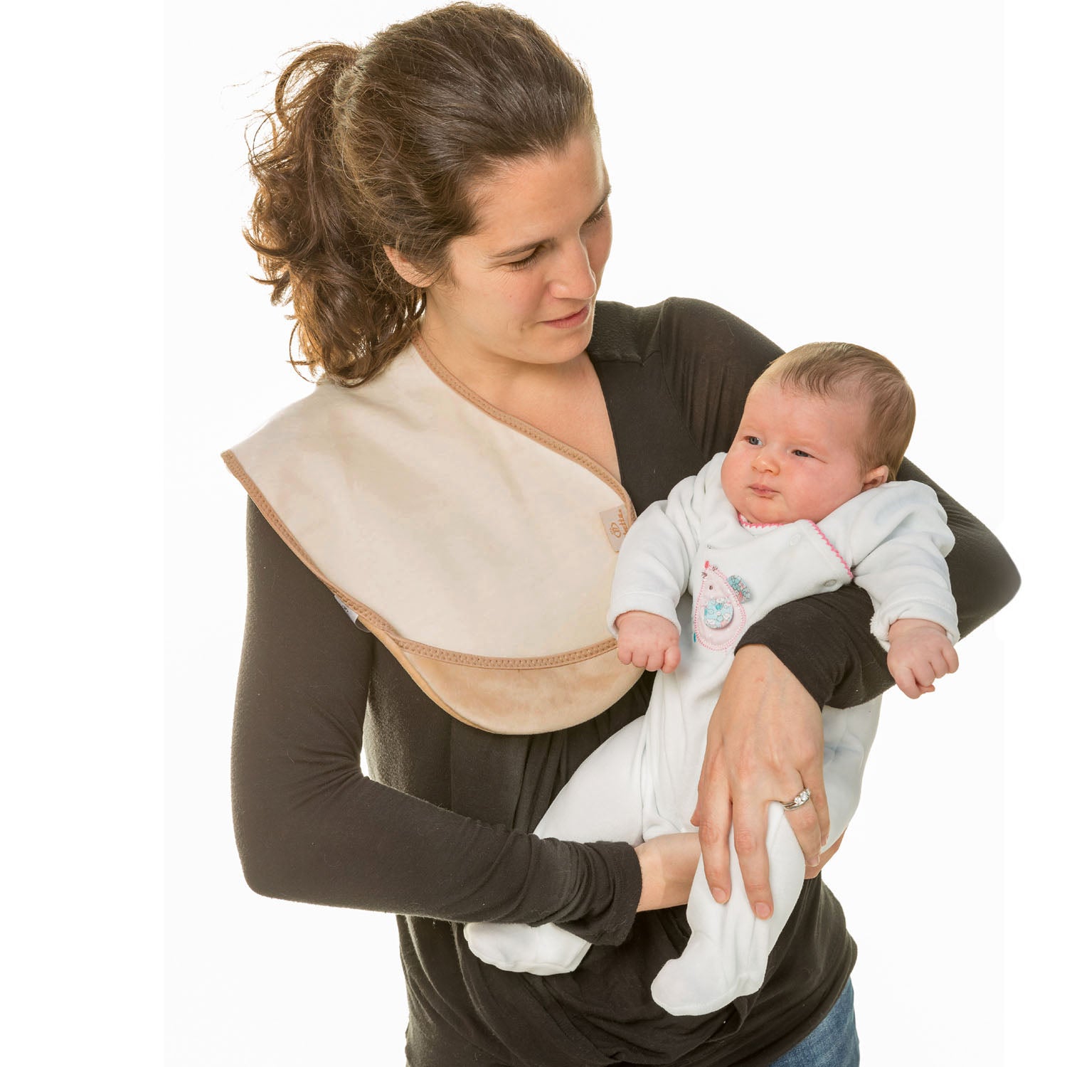 lady with dark hair up in a pnytail wearing a long brown t-shirt holding a baby in a white onesie with a Bibetta cream burp cloth on her shoulder